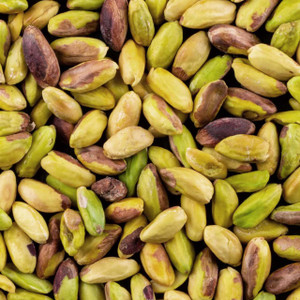 Close-up of peeled green pistachio nuts showing their vibrant natural colours and smooth texture, ideal for snacking, baking, and cooking.