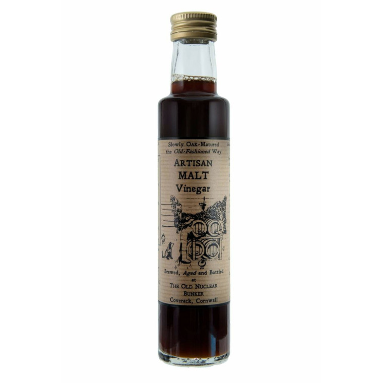 A 250ml glass bottle of Artisan Malt Vinegar with a gold screw cap and a vintage-style brown label reading "Artisan Malt Vinegar – Brewed, Aged and Bottled at The Old Nuclear Bunker, Coverack, Cornwall." The label also shows traditional oak barrels and a hand-drawn illustration, emphasising the product's small-batch and traditional oak-aged production.