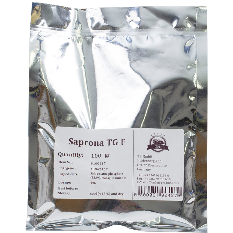 Silver foil pouch of Meat Glue 100g (Transglutaminase), labelled for culinary use in binding meat and fish for terrines, roulades, and restructured cuts.