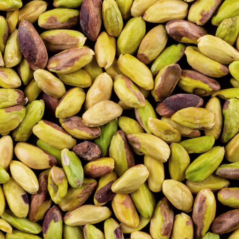 Close-up of peeled green pistachio nuts showing their vibrant natural colours and smooth texture, ideal for snacking, baking, and cooking.