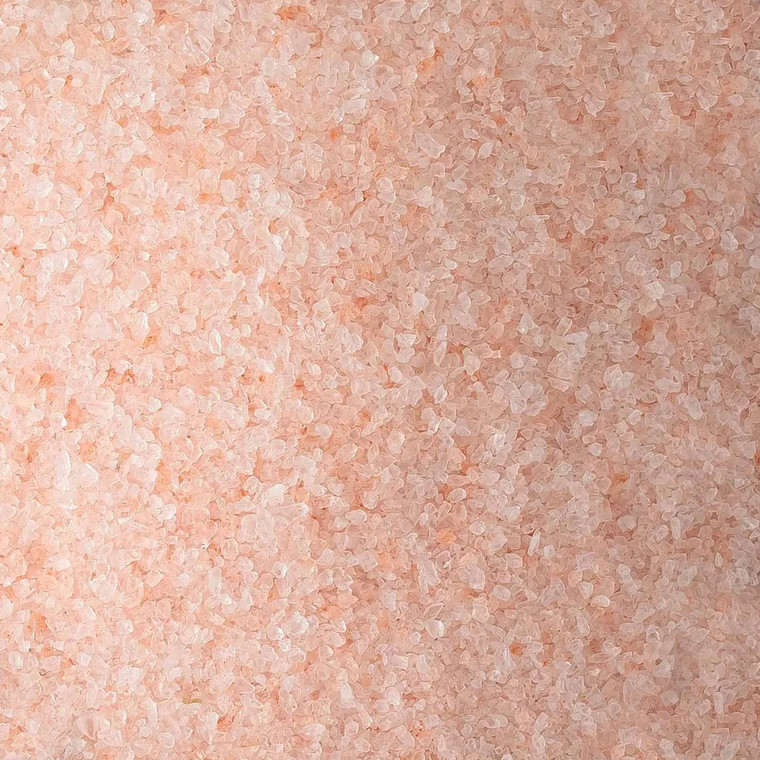Close-up of pink Himalayan salt crystals used for seasoning and cooking, showing natural rose-coloured granules in coarse texture.