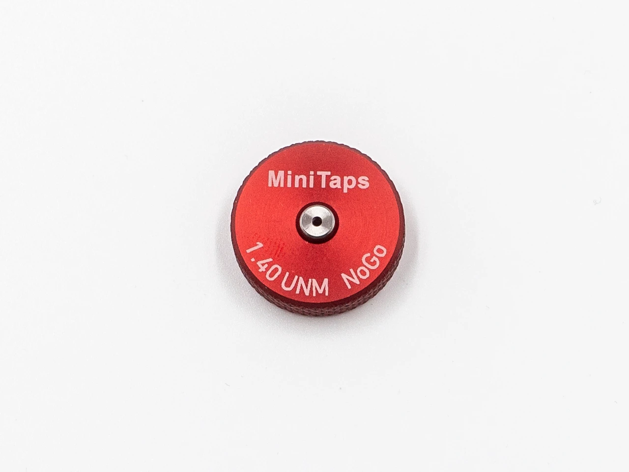 Front Side:  Metric Thread Ring Gage 1.40UNM also M1.4 pitch 0.30mm Class 6g; "No-Go" Ring member Precision Thread Gage made of High Speed Steel then hardened. Brand is Minitaps Made in Switzerland to our specifications. Picture is an representative of the actual gages.