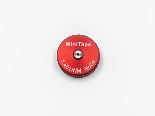 Front Side:  Metric Thread Ring Gage 1.40UNM also M1.4 pitch 0.30mm Class 6g; "No-Go" Ring member Precision Thread Gage made of High Speed Steel then hardened. Brand is Minitaps Made in Switzerland to our specifications. Picture is an representative of the actual gages.