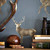 Majestic deer stand proudly and spaced apart on this smart wallpaper design, ideal for modern living spaces or more traditional reading rooms. Subtle golden metallic inks are printed beneath the hand drawn penwork and is available in both dark and light colourways. A fabric of the same name is also available.