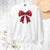 Christmas Bow Unisex Sweatshirt featuring a cute Santa bow design, Ideal for holiday celebrations and spreading festive cheer!