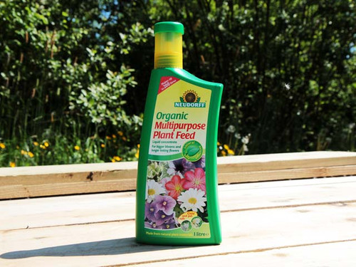 Bottle of multipurpose feed in a garden