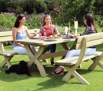 Three women enjoying themselves at a garden table