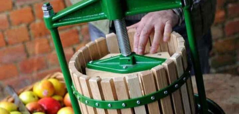 Vigo crusher in operation with basket of apples in the background