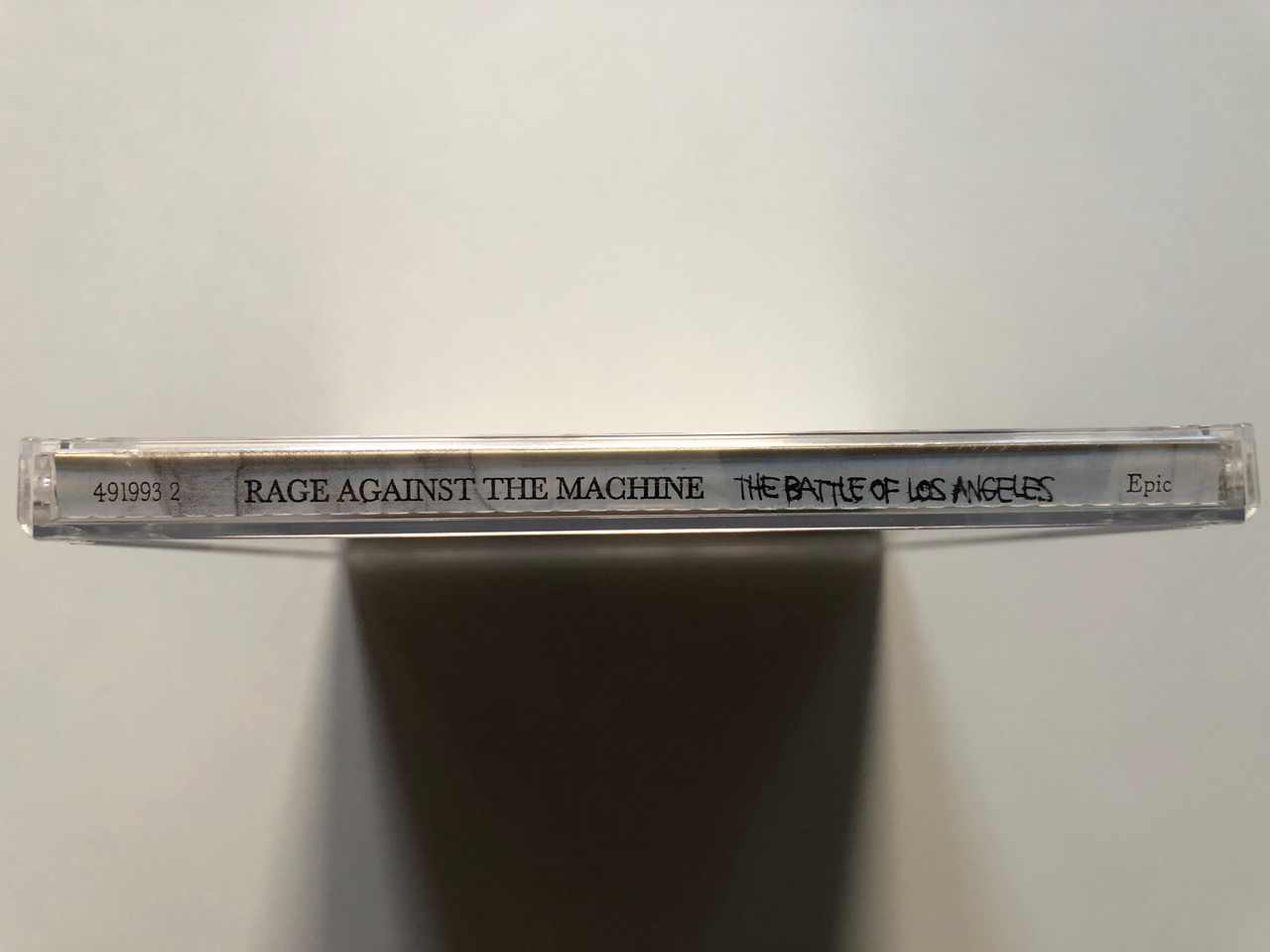 https://cdn11.bigcommerce.com/s-62bdpkt7pb/products/0/images/315288/Rage_Against_The_Machine_The_Battle_Of_Los_Angeles_Epic_Audio_CD_1999_491993_2_3__57582.1701966109.1280.1280.JPG?c=2