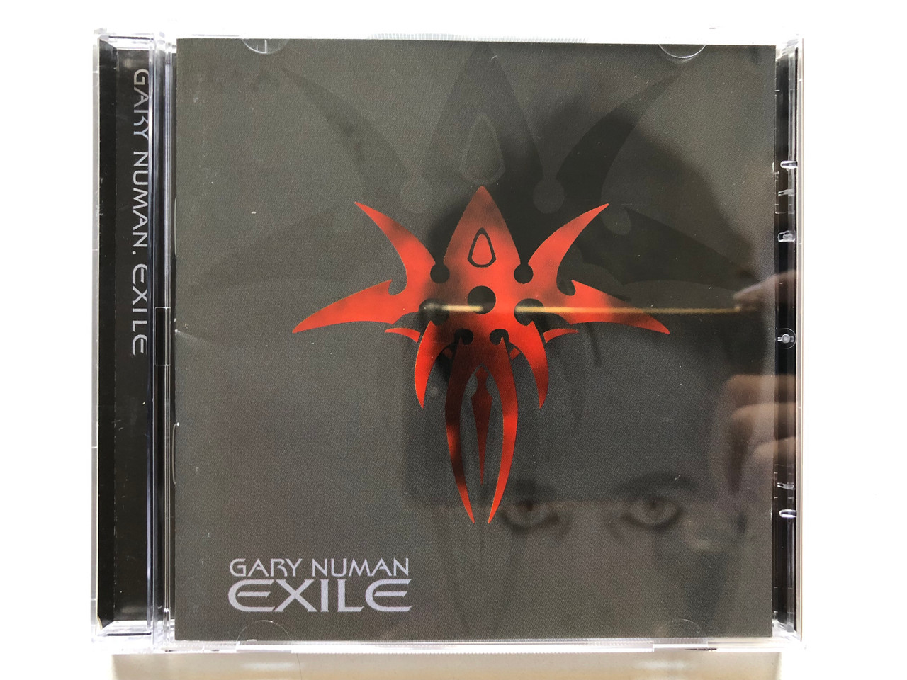 https://cdn11.bigcommerce.com/s-62bdpkt7pb/products/0/images/316347/Gary_Numan_Exile_Eagle_Records_Audio_CD_1997_EAGCD008_1__60816.1702488020.1280.1280.JPG?c=2