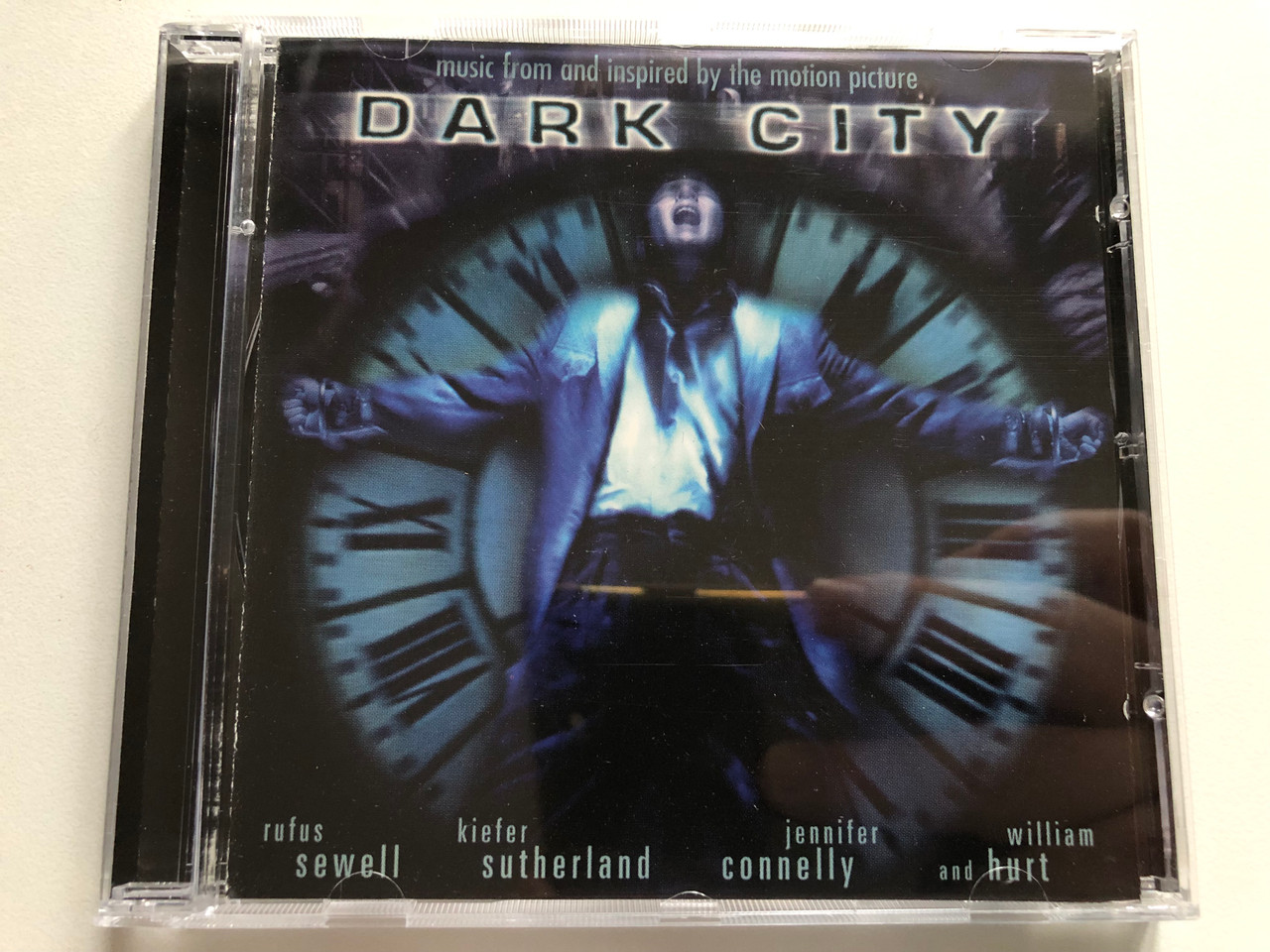 https://cdn11.bigcommerce.com/s-62bdpkt7pb/products/0/images/316530/Dark_City_Music_From_And_Inspired_By_The_Motion_Picture_-_Rufus_Sewell_Kiefer_Sutherland_Jennifer_Connelly_And_William_Hurt_Madfish_Movies_Audio_CD_1998_SMACD810_1__12530.1702638382.1280.1280.JPG?c=2