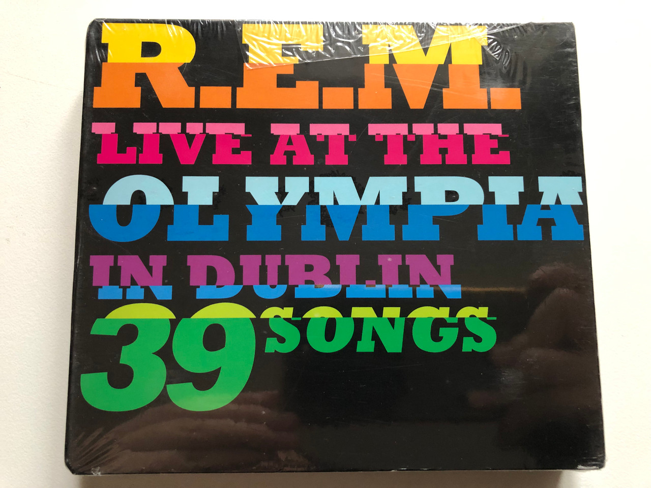 https://cdn11.bigcommerce.com/s-62bdpkt7pb/products/0/images/316749/R.E.M._Live_At_The_Olympia_In_Dublin_39_Songs_Warner_Bros._Records_2x_Audio_CD_DVD_Video_CD_2009_9362-49748-1_1__19006.1702917249.1280.1280.JPG?c=2