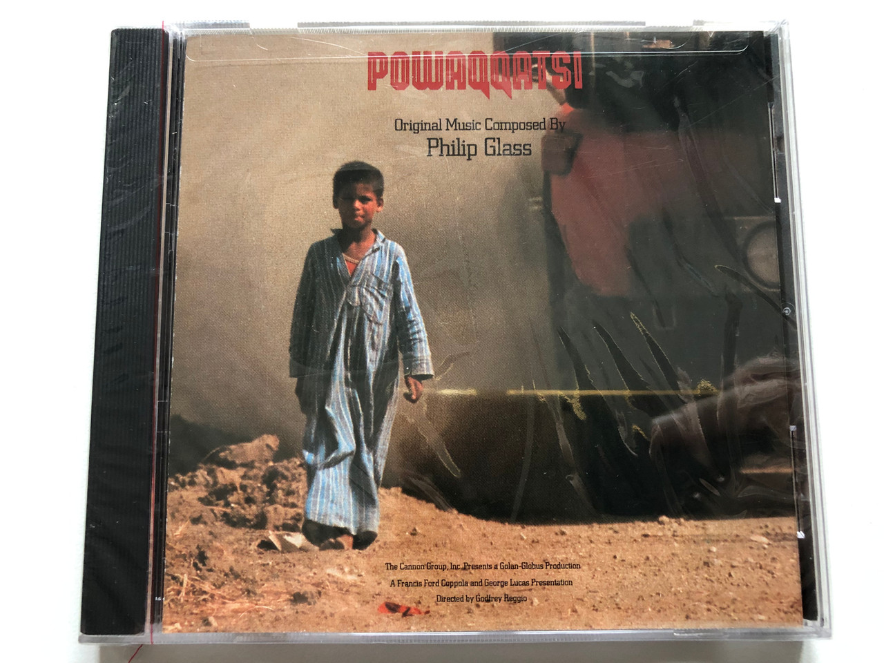 https://cdn11.bigcommerce.com/s-62bdpkt7pb/products/0/images/319811/Powaqqatsi_-_Original_Music_Composed_By_Philip_Glass_Directed_By_Godfrey_Reggio_Elektra_Nonesuch_Audio_CD_1988_9_79192-2_1__17152.1704286136.1280.1280.JPG?c=2