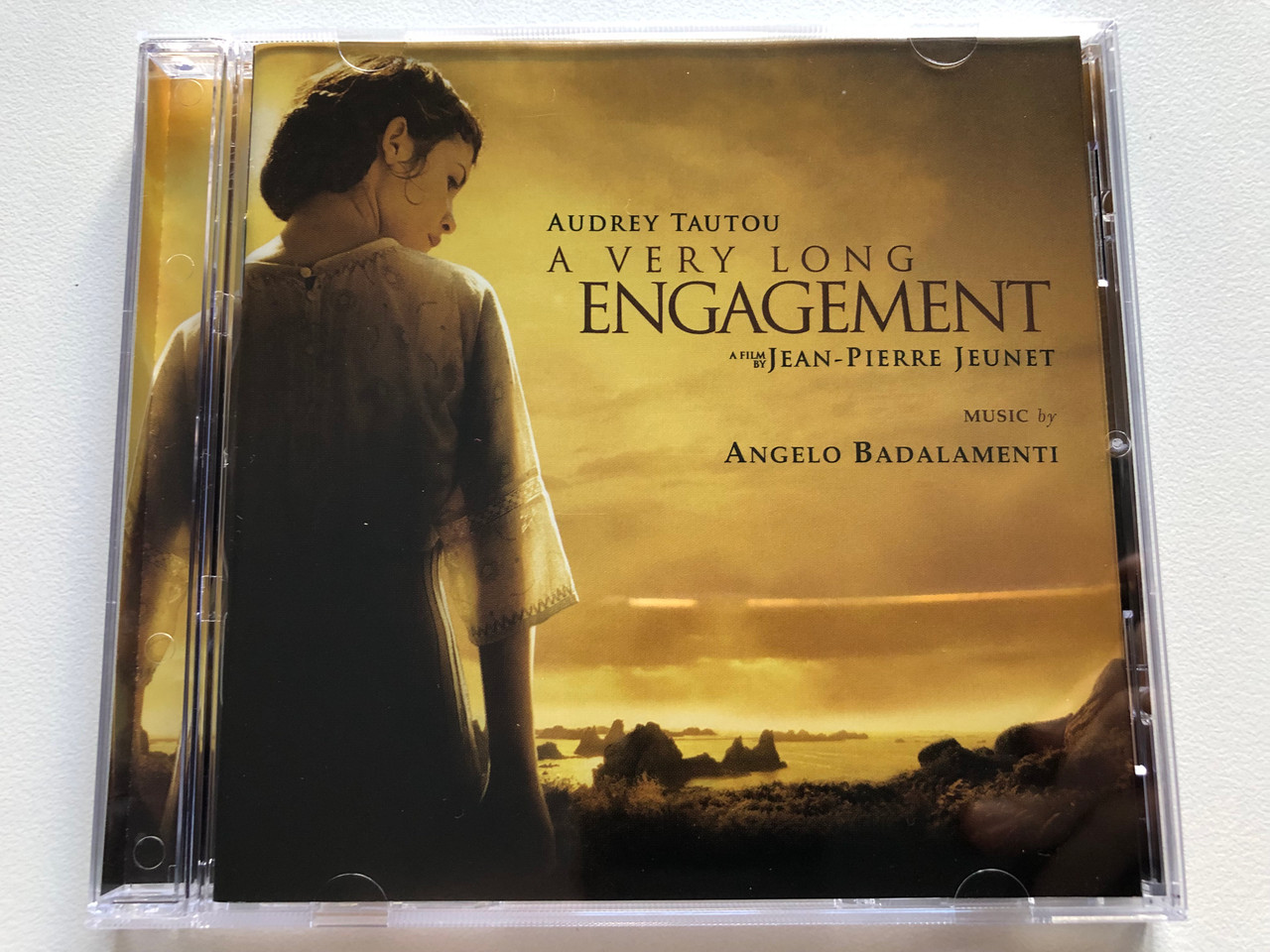 https://cdn11.bigcommerce.com/s-62bdpkt7pb/products/0/images/320999/Audrey_Tautou_A_Very_Long_Engagement_-_A_Film_By_Jean-Pierre_Jeunet_Music_By_Angelo_Badalamenti_Nonesuch_Audio_CD_79880-2_1__77730.1704864809.1280.1280.JPG?c=2