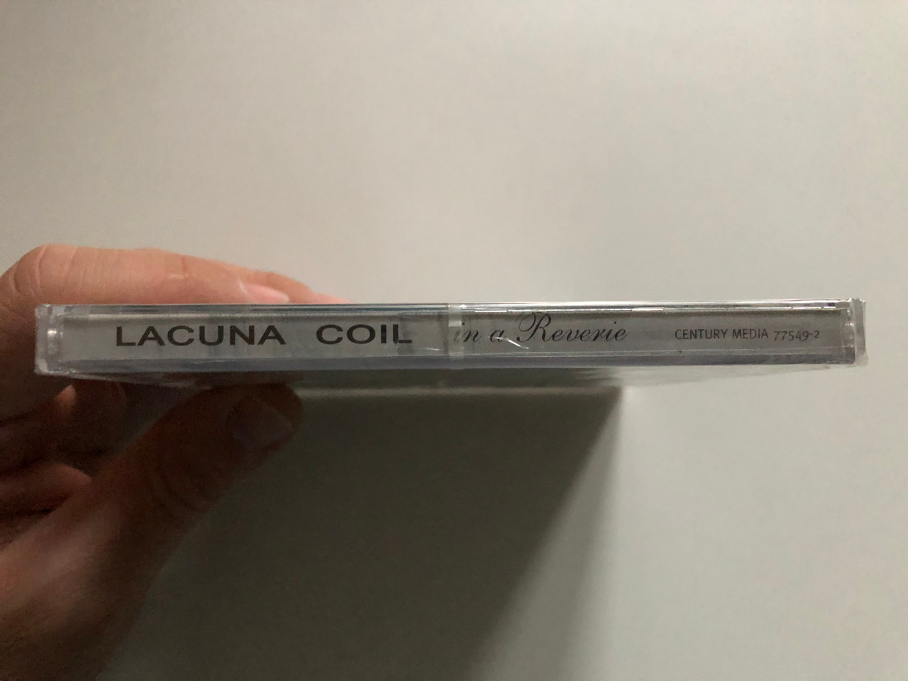 https://cdn11.bigcommerce.com/s-62bdpkt7pb/products/0/images/321787/Lacuna_Coil_In_A_Reverie_Their_classic_debut_album_now_available_with_new_artwork_Incl._wallpapers_Enter_the_coil..._Century_Media_Audio_CD_2005_77549-2_3__86231.1705477739.1280.1280.JPG?c=2