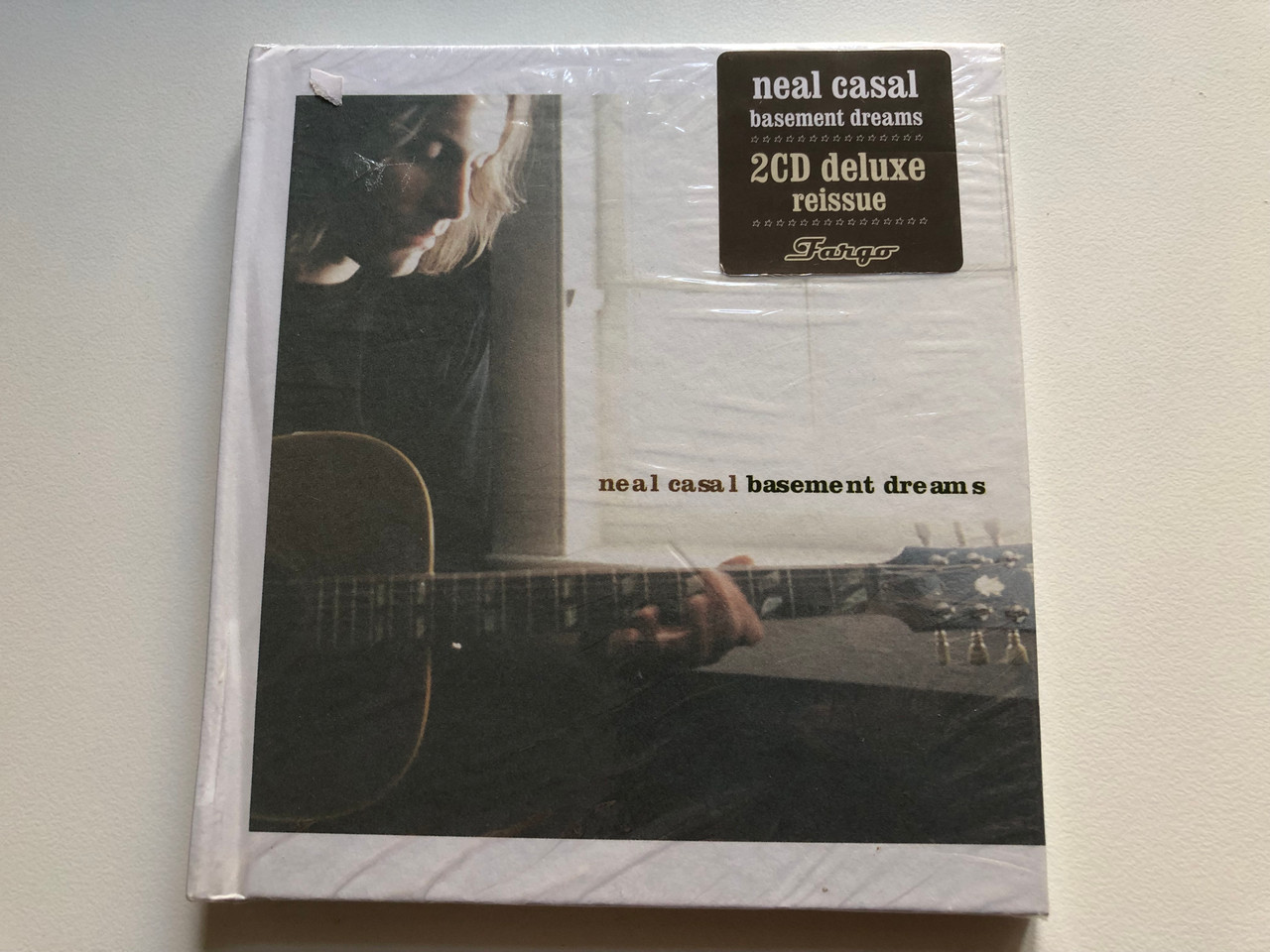 https://cdn11.bigcommerce.com/s-62bdpkt7pb/products/0/images/322895/Neal_Casal_Basement_Dreams_Fargo_Records_2x_Audio_CD_2010_FR21201_1__17850.1706695428.1280.1280.JPG?c=2