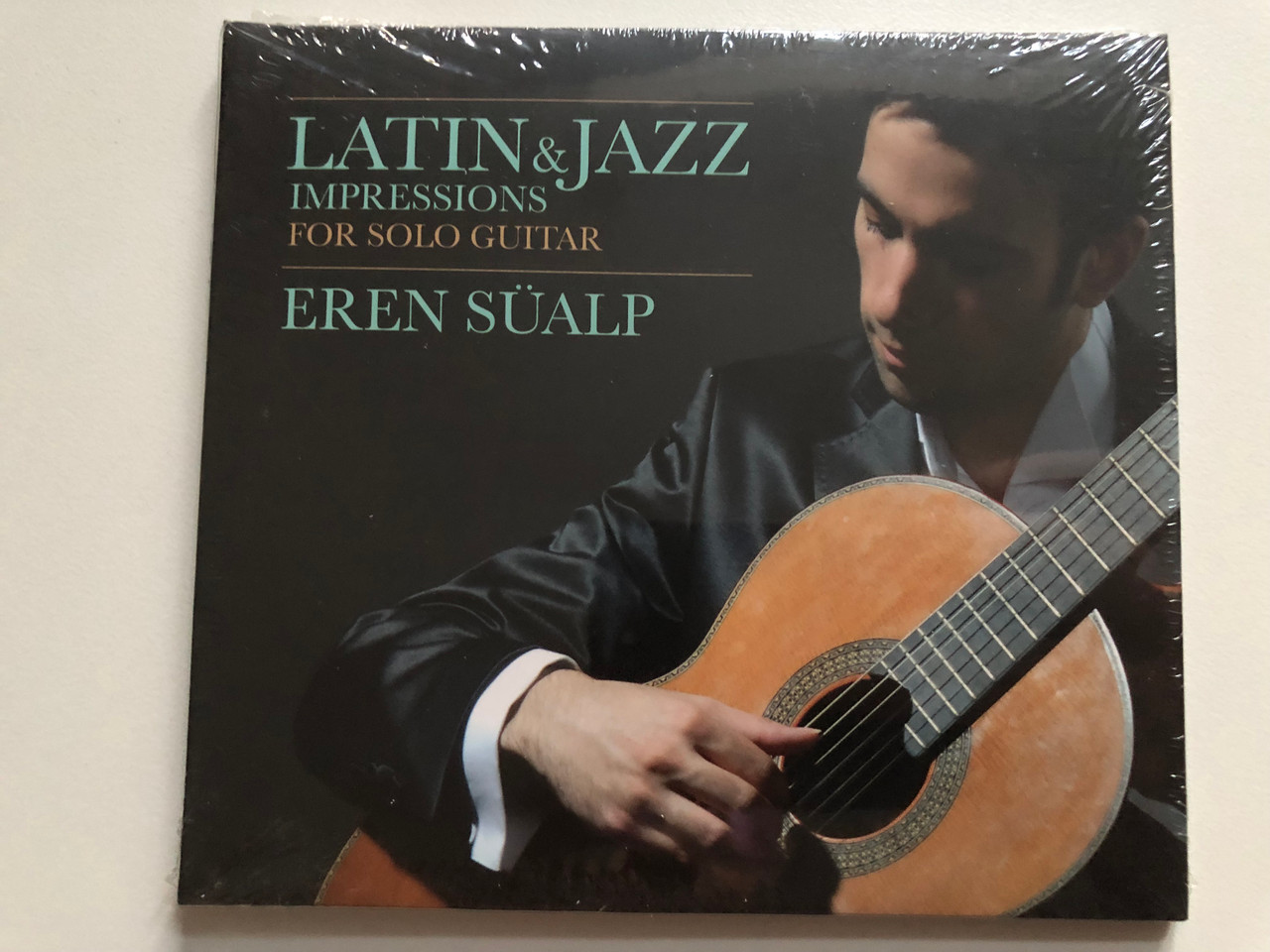 https://cdn11.bigcommerce.com/s-62bdpkt7pb/products/0/images/323071/Latin_Jazz_Impressions_For_Solo_Guitar_-_Eren_Sualp_Vemedya_Yapim_Audio_CD_8680845096974_1__59693.1706771716.1280.1280.JPG?c=2