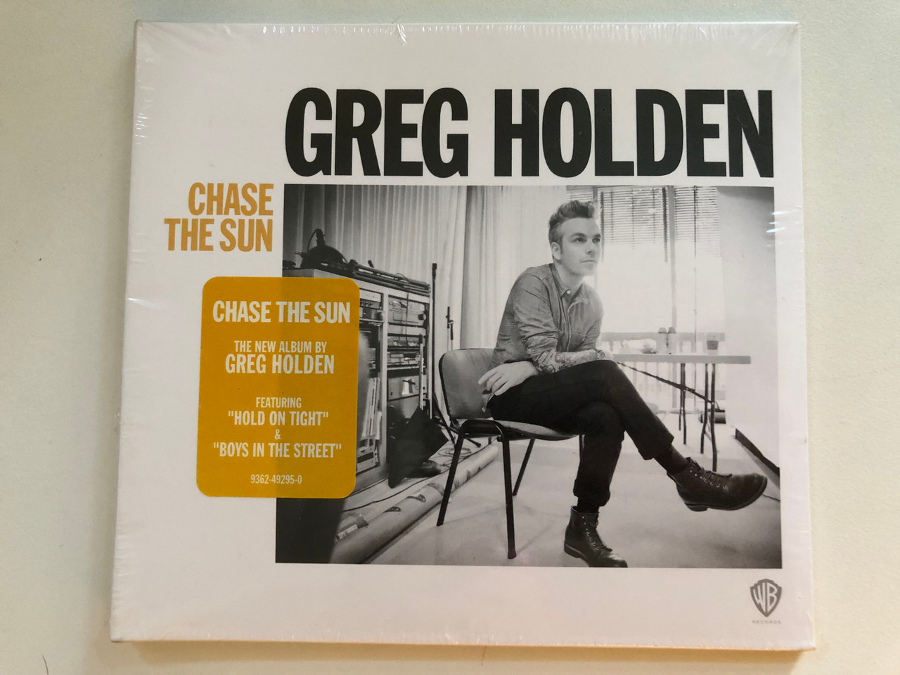 https://cdn11.bigcommerce.com/s-62bdpkt7pb/products/0/images/323530/Greg_Holden_Chase_The_Sun_Featuring_Hold_On_Tight_Boys_In_the_Street_WEA_Audio_CD_2015_9362-49295-0_1__17498.1707121805.1280.1280.JPG?c=2