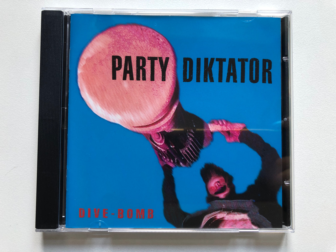 https://cdn11.bigcommerce.com/s-62bdpkt7pb/products/0/images/329389/Party_Diktator_Dive-Bomb_Roadrunner_Records_Audio_CD_1996_RR_8888_2_1__73633.1711390193.1280.1280.JPG?c=2