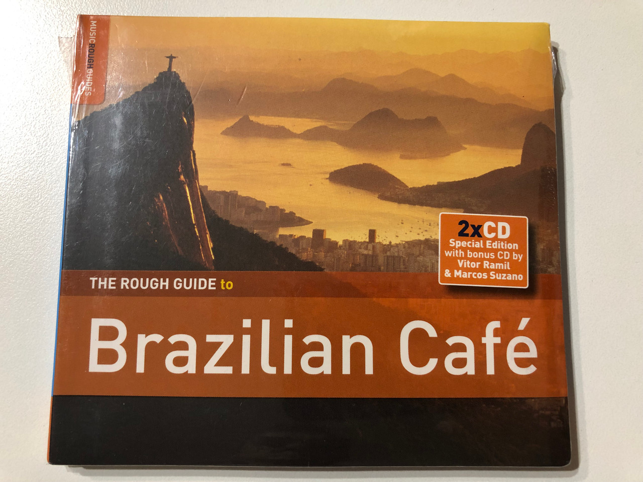 https://cdn11.bigcommerce.com/s-62bdpkt7pb/products/0/images/331852/The_Rough_Guide_To_Brazilian_Caf_World_Music_Network_2x_Audio_CD_2011_RGNET1257CD_1__16792.1713947652.1280.1280.JPG?c=2