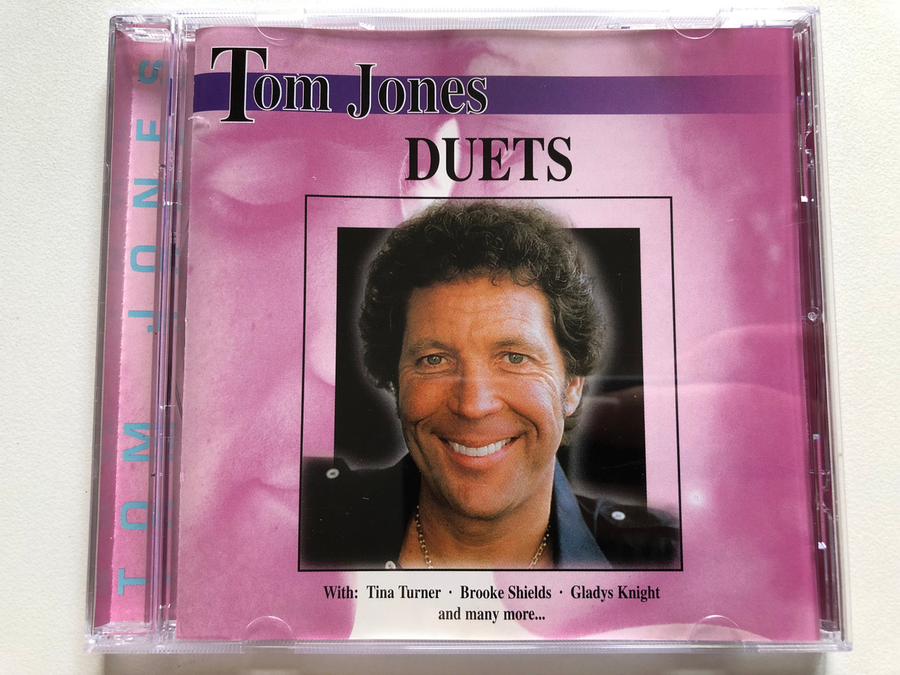 https://cdn11.bigcommerce.com/s-62bdpkt7pb/products/0/images/338654/Tom_Jones_Duets_-_with_Tina_Turner_Brooke_Shields_Gladys_Knight_and_many_more..._Elap_Music_Audio_CD_1999_50163372_1__92228.1719550448.1280.1280.JPG?c=2