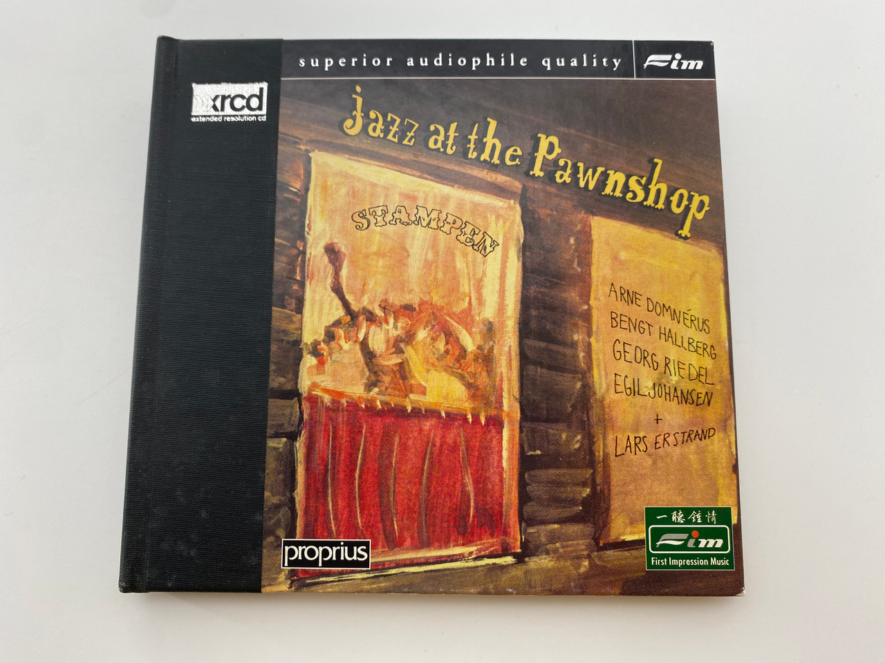 https://cdn11.bigcommerce.com/s-62bdpkt7pb/products/0/images/349137/Jazz_At_The_Pawnshop_-_Arne_Domnrus_Bengt_Hallberg_Georg_Riedel_Egil_Johansen_Lars_Erstrand_First_Impression_Music_2x_Audio_CD_1997_FIM_XRCD_012013_1__76628.1727272032.1280.1280.jpg?c=2