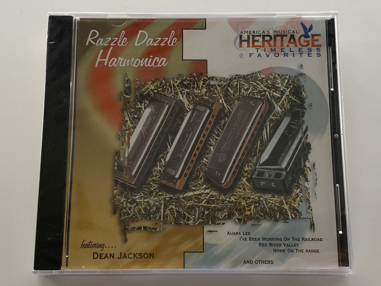 https://cdn11.bigcommerce.com/s-62bdpkt7pb/products/0/images/354202/American_Heritage_Razzle_Dazzle_Harmonica_-_featuring..._Dean_Jackson_Auara_Lee_Ive_Been_Working_On_The_Railroad_Red_River_Valley_Home_On_The_Range_and_others_KRB_Music_Companies_Audio_1__55169.1728935414.1280.1280.jpg?c=2