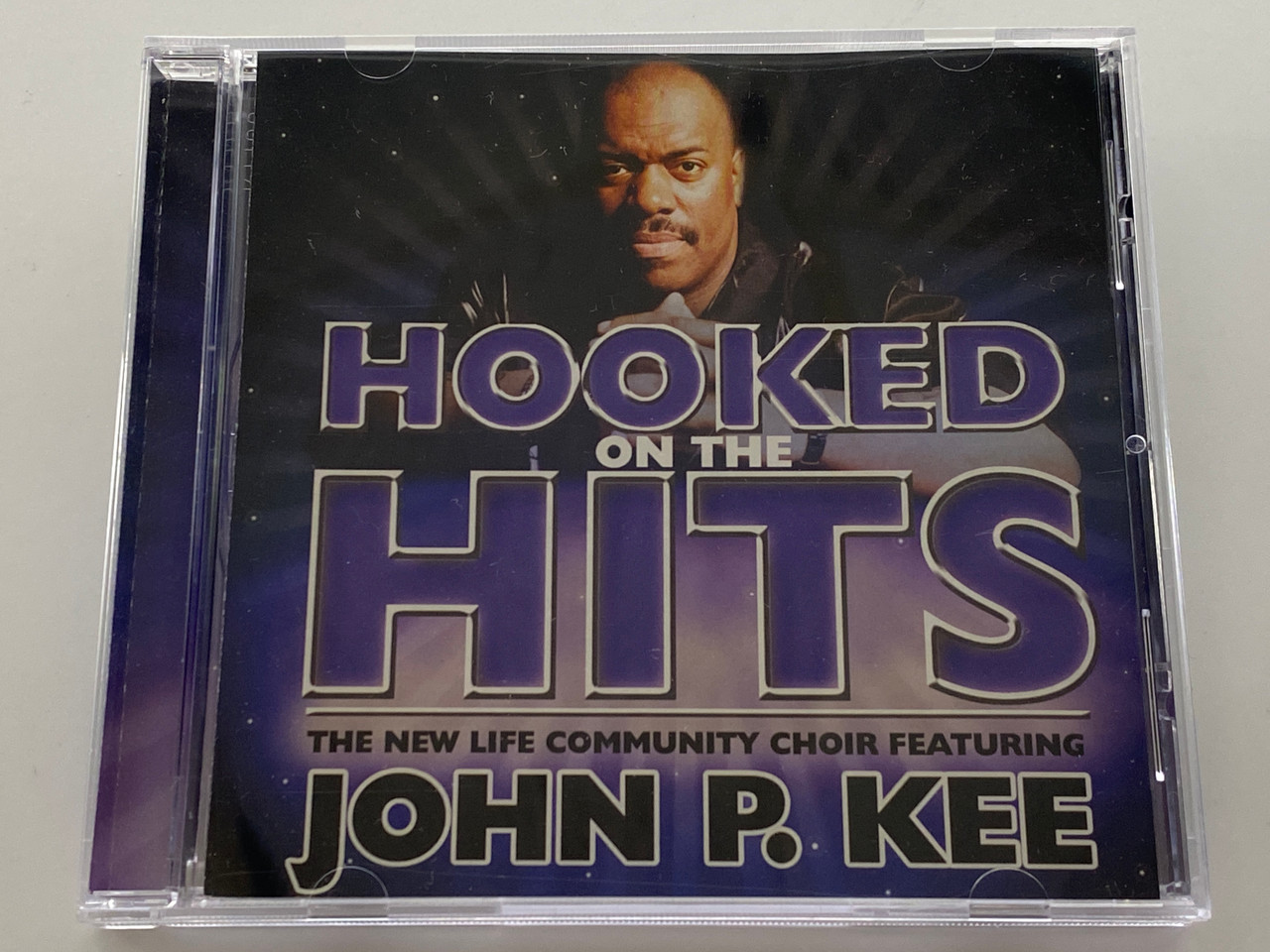 https://cdn11.bigcommerce.com/s-62bdpkt7pb/products/0/images/356463/Hooked_On_The_Hits_-_The_New_Life_Community_Choir_Featuring_John_P._Kee_Zomba_Recording_Corporation_Audio_CD_2003_82876-53711-2_1__33486.1729708668.1280.1280.jpg?c=2