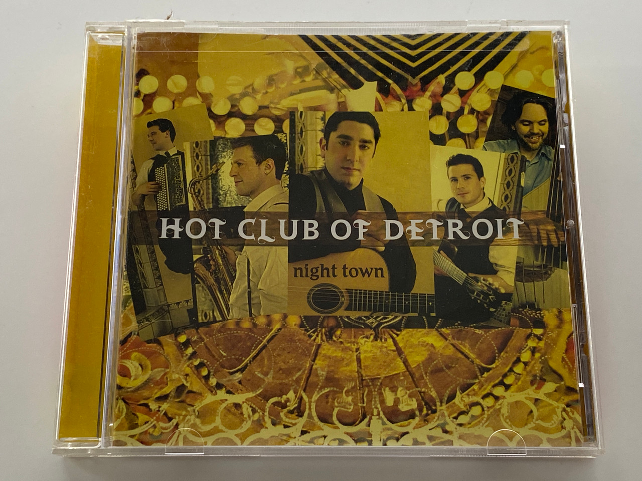 https://cdn11.bigcommerce.com/s-62bdpkt7pb/products/0/images/356623/Hot_Club_Of_Detroit_Night_Town_Mack_Avenue_Audio_CD_2008_MAC_1041_1__68794.1729790185.1280.1280.jpg?c=2