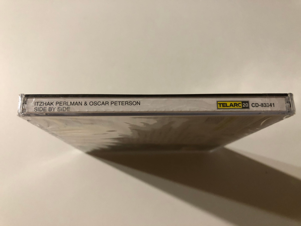 https://cdn11.bigcommerce.com/s-62bdpkt7pb/products/0/images/357175/Perlman_Oscar_Peterson_Side_By_Side_-_Herb_Ellis_guitar_Ray_Brown_bass_Grady_Tate_drums_Telarc_Audio_CD_1994_CD-83341_3__87435.1730120764.1280.1280.JPG?c=2