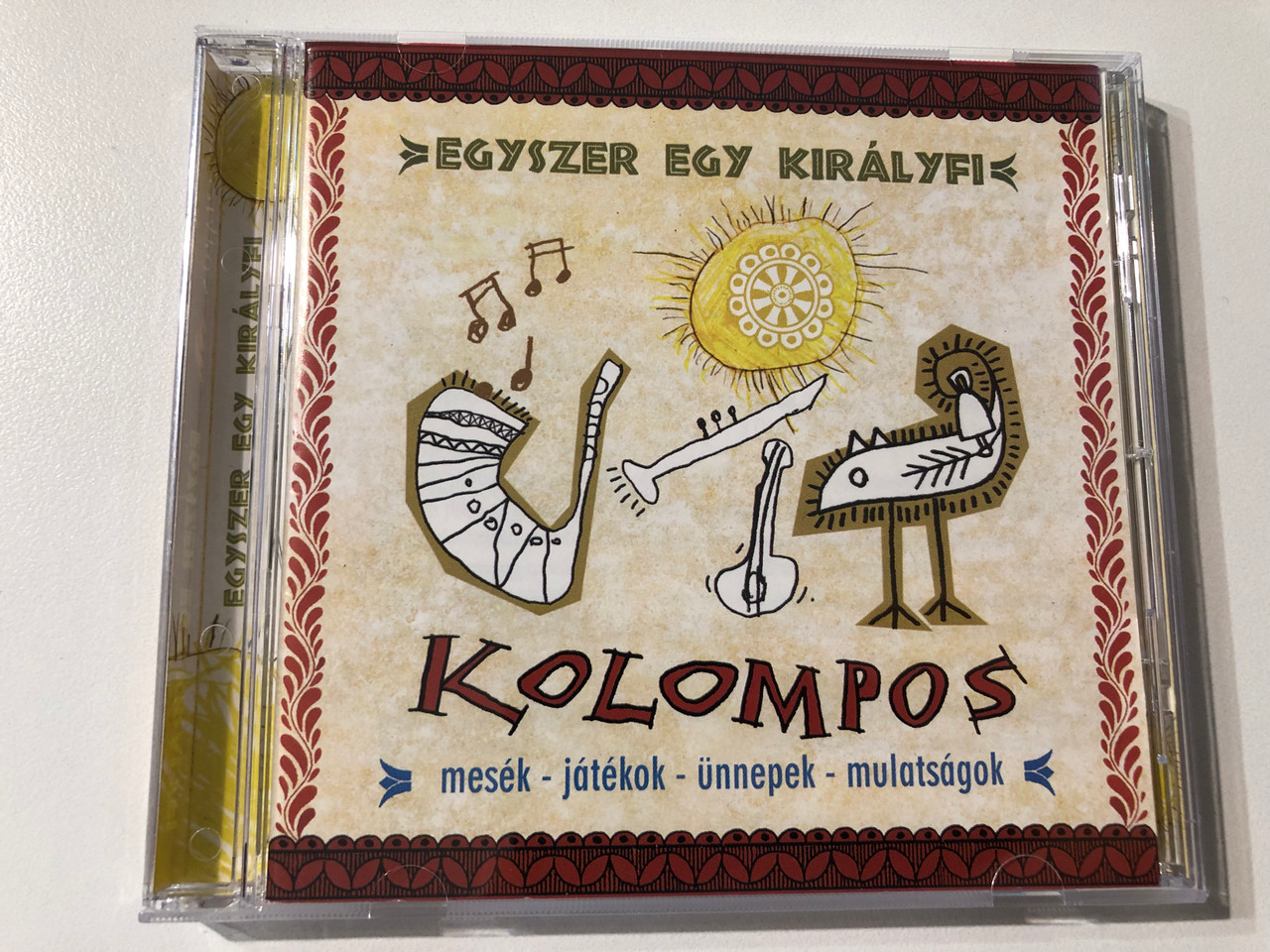 https://cdn11.bigcommerce.com/s-62bdpkt7pb/products/0/images/357407/Kolompos_Egyszer_Egy_Kirlyfi_Mesk_Jtkok_nnepek_Mulatsgok_Kolompos_Kkt._Audio_CD_2001_K-01_1__16005.1730364280.1280.1280.JPG?c=2