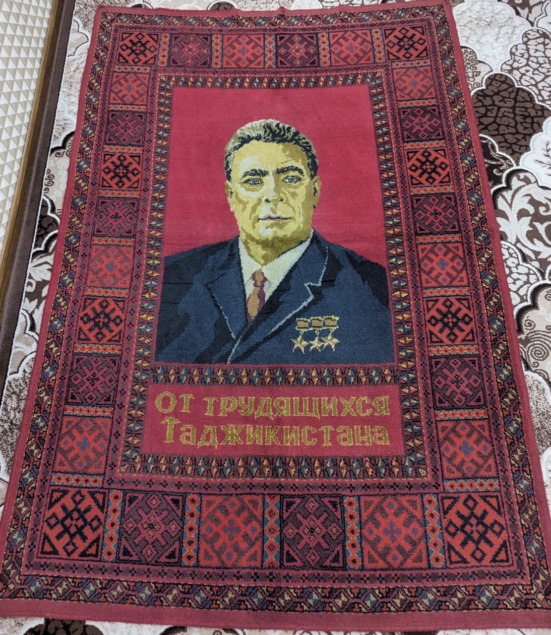https://cdn11.bigcommerce.com/s-62bdpkt7pb/products/64390/images/325413/Wall_Carpet_from_the_Soviet_Union_with_the_portrait_Leonid_Brezhnev_1__39239.1708895226.1280.1280.jpg?c=2