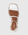 Emmy White Leather Flat Strappy Sandal. 