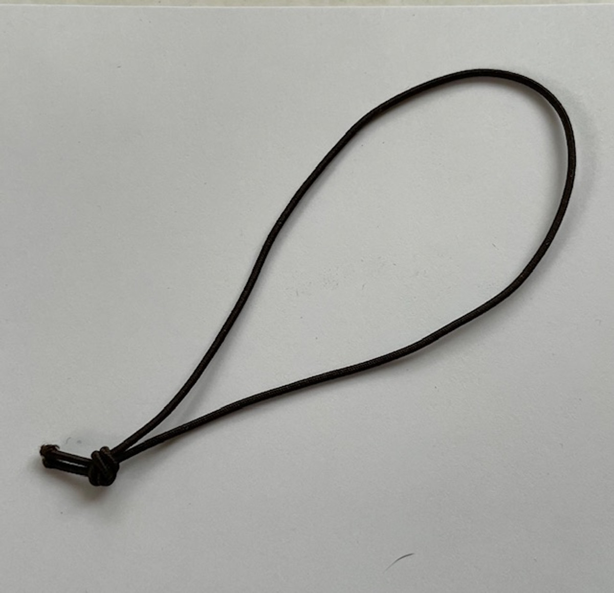 Dark brown 1/16" elastic, 4" long knotted loop