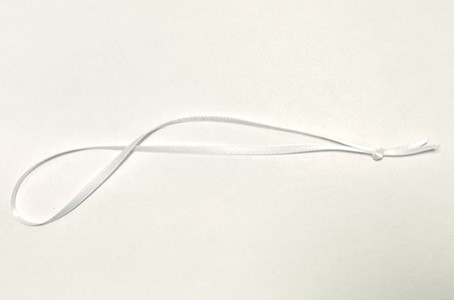 1/8" wide satin ribbon in white, in a 5" long knotted loop