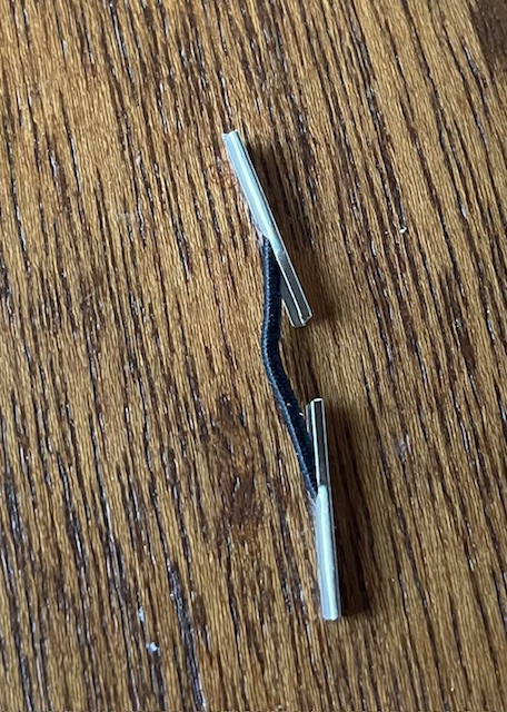 1/16" black elastic, .75" between silver barb on each end.
