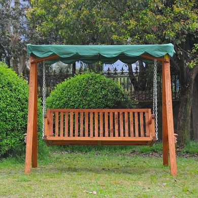 A serene outdoor scene featuring the Outsunny 3-Seater Wooden Garden Swing Chair Seat Bench in the green version. The swing chair is beautifully crafted with a sturdy larch wood frame and features a water-resistant wavy edge canopy in a vibrant shade of green.