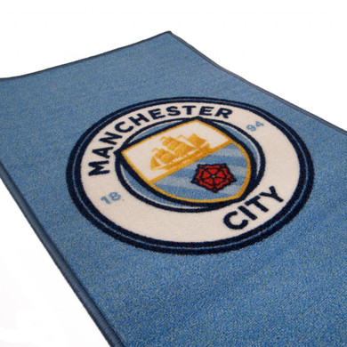 Manchester City FC Rug featuring a vibrant club crest design, made from 100% polyamide, machine washable with non-slip backing - Officially licensed football club merchandise - Dimensions: 80cm x 50cm