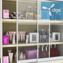 Lockable sliding doors on a platinum gondola, securing expensive cosmetics on a 4-foot-wide, 84-inch-high display.