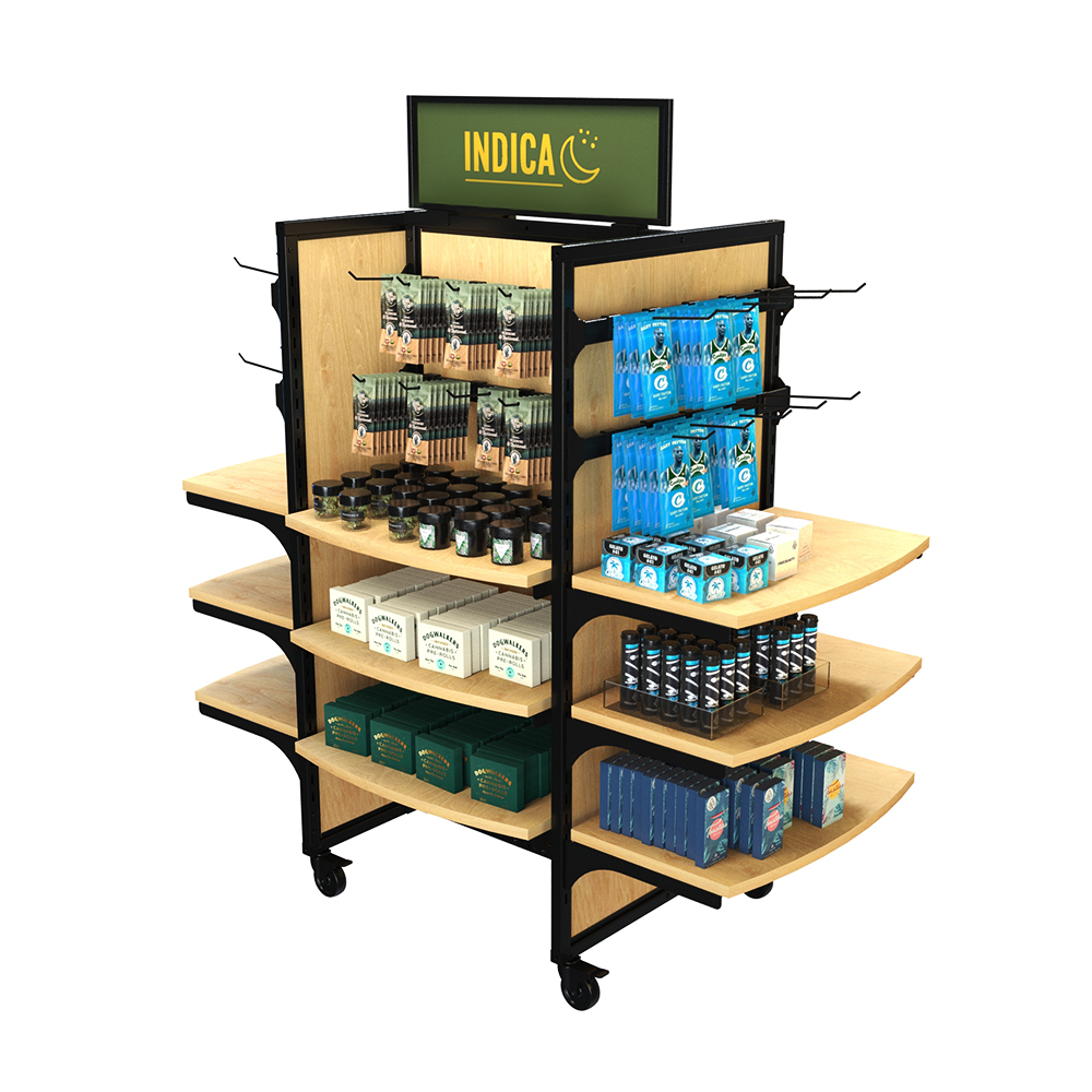 Rolling cigarette and tobacco display rack measuring 59 inches wide, 62 inches high, and 31 inches deep, with 12 curved wooden shelves, 8 horizontal hangbars, and 40 metal peghooks. The freestanding black metal and wood unit is stocked with hanging smoking product pouches, cannabis flower jars, boxed cannabis pre-rolls, and other packaged goods. The top signage panel reads ‘Indica’ in bold yellow letters with a crescent moon icon, making it ideal for dispensaries, smoke shops, and convenience store tobacco sections.