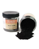 Rublev Colours Natural Black Oxide PBk 11 jar tipped over with black iron oxide pigment powder spilled out, 100g artist dry pigment