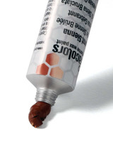 Ceracolors Burnt Sienna tube squeezing out beeswax-based paint onto white background showing smooth paste consistency for impasto