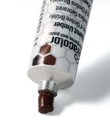 Ceracolors Burnt Umber tube squeezing out beeswax-based paint onto white background showing smooth paste consistency for impasto