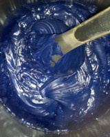 Rublev Colours lazurite oil paint in industrial mixer during manufacturing, showing deep ultramarine blue paint mass
