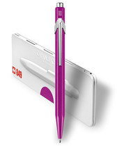 Caran d’Ache 849 Metal-X Violet ballpoint shown with metal presentation tin—Swiss-made, refillable, 849.850.