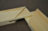 Close-up of corner joint of two canvas stretcher bars, highlighting finger-spliced, kiln-dried pine for strength and precision, perfect for supporting large or custom canvas projects.