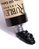 Close-up of Rublev Bone Black oil paint tube squeezing thick PBk9 black paint onto white surface
