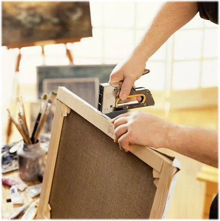 Rapid R23 Staple Gun being used for canvas stretching, demonstrating its precision stapling and ergonomic design