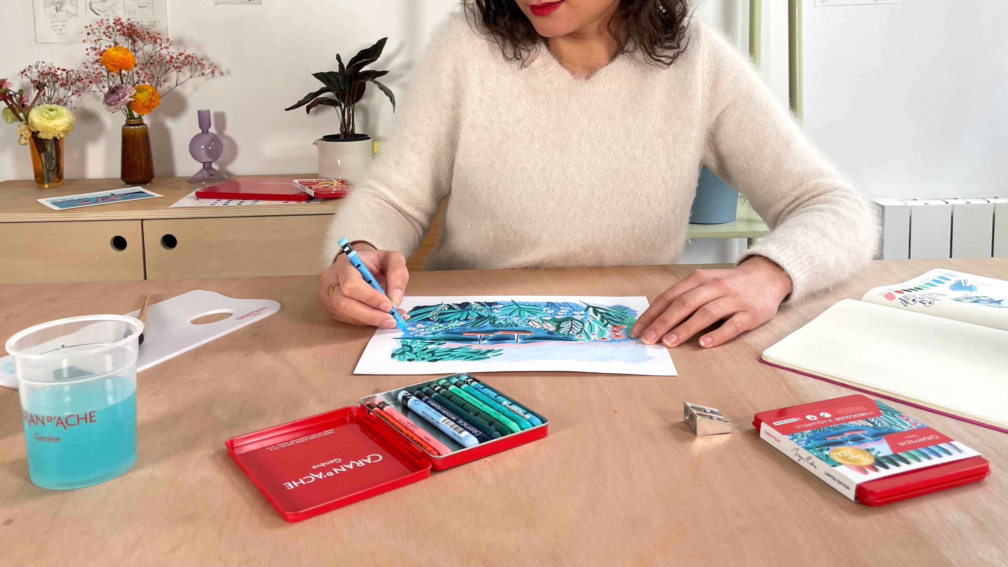 Wet brush activating Neocolor II violet swatch—smooth watercolor wash from water-soluble pastel.