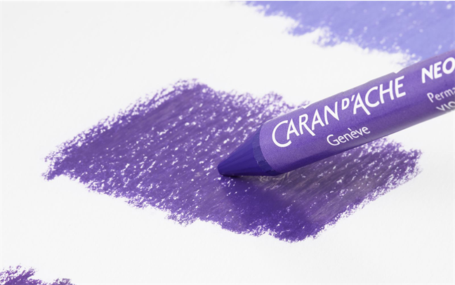 Close-up of Neocolor II pastel laying dense violet colour—creamy texture before water activation.